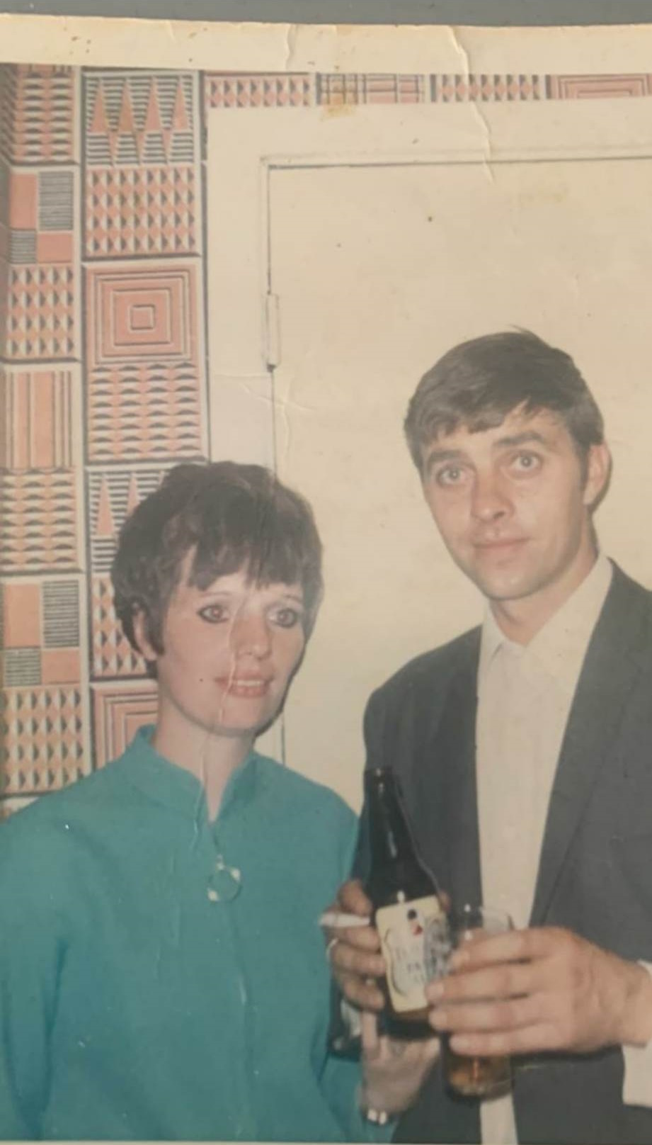 Old damaged black and white photo of father and son before restoration - showing tears and fading